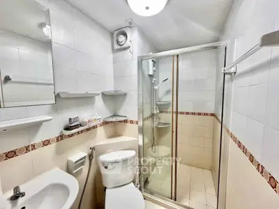 Compact bathroom with shower and modern fixtures in a real estate property.