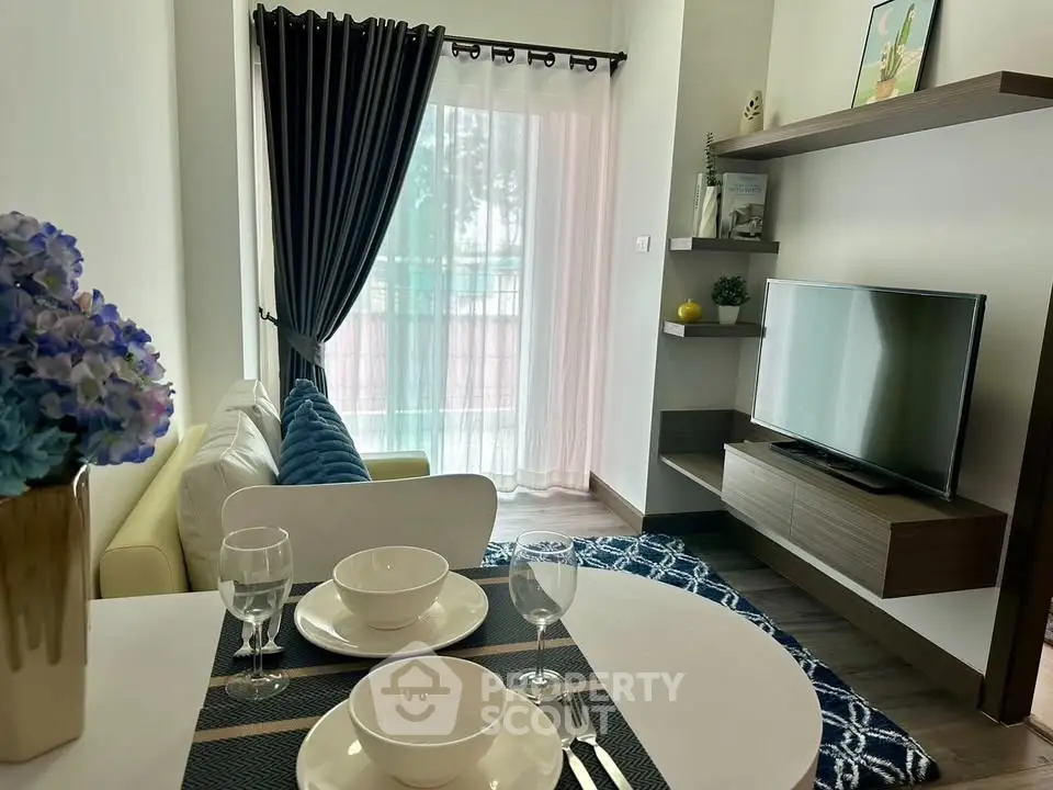 Modern living room with stylish decor and natural light, featuring a cozy seating area and elegant dining setup.