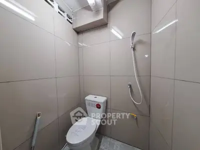 Modern bathroom with sleek tiles and shower setup