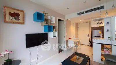 Modern living room with stylish decor and open kitchen layout in a contemporary apartment.