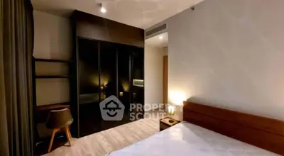 Modern bedroom with sleek black wardrobe and cozy lighting