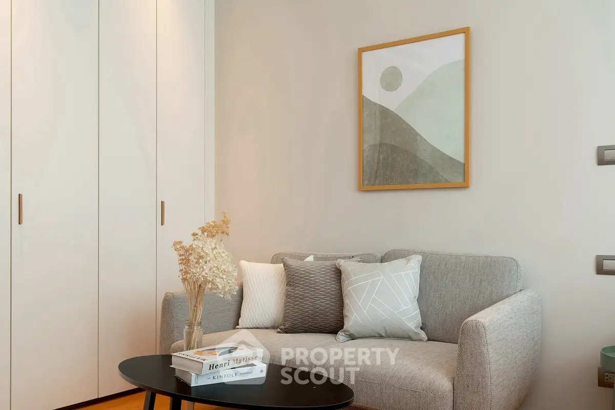 Cozy living room with modern sofa, stylish decor, and elegant wall art, perfect for relaxation and comfort.
