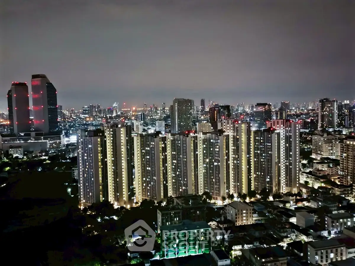 Stunning night view of illuminated high-rise buildings in a bustling cityscape.