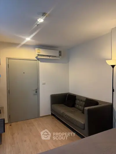 Cozy living room with modern sofa and air conditioning in a stylish apartment.