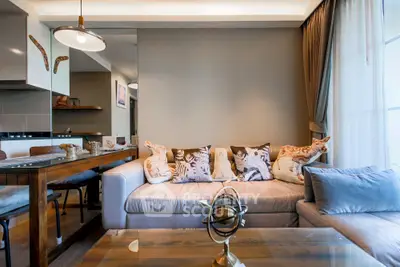 Stylish living room with modern decor and cozy seating in a contemporary apartment.