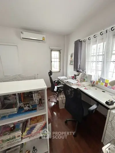 Cozy study room with ample natural light and organized workspace