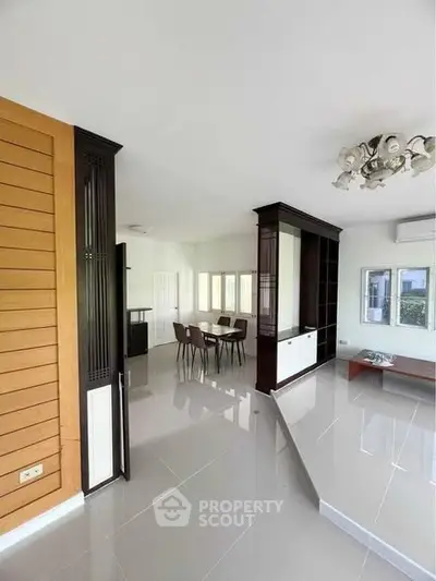 Spacious modern living room with elegant dining area and sleek flooring