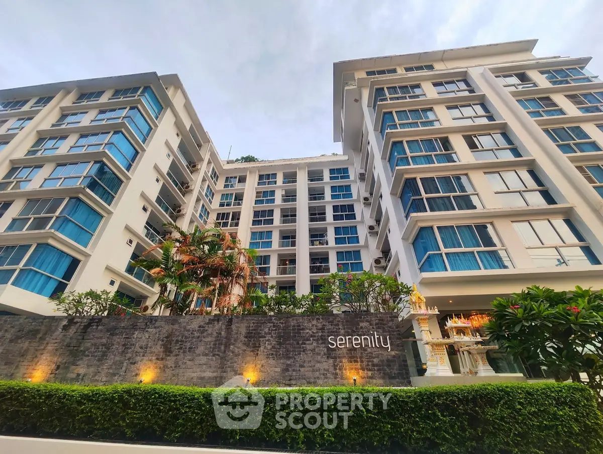 Modern high-rise building with lush landscaping and elegant facade