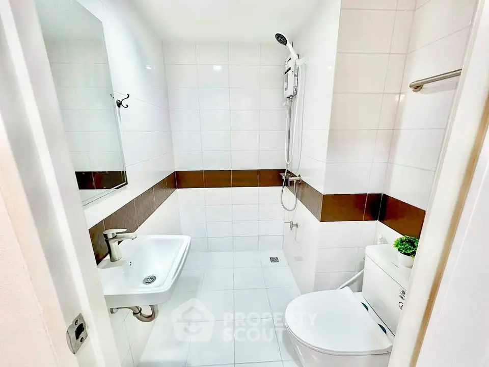 Modern bathroom with sleek white tiles and contemporary fixtures