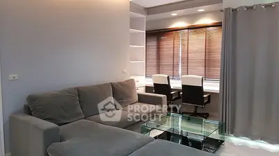 Modern living room with cozy sofa and study area with natural light