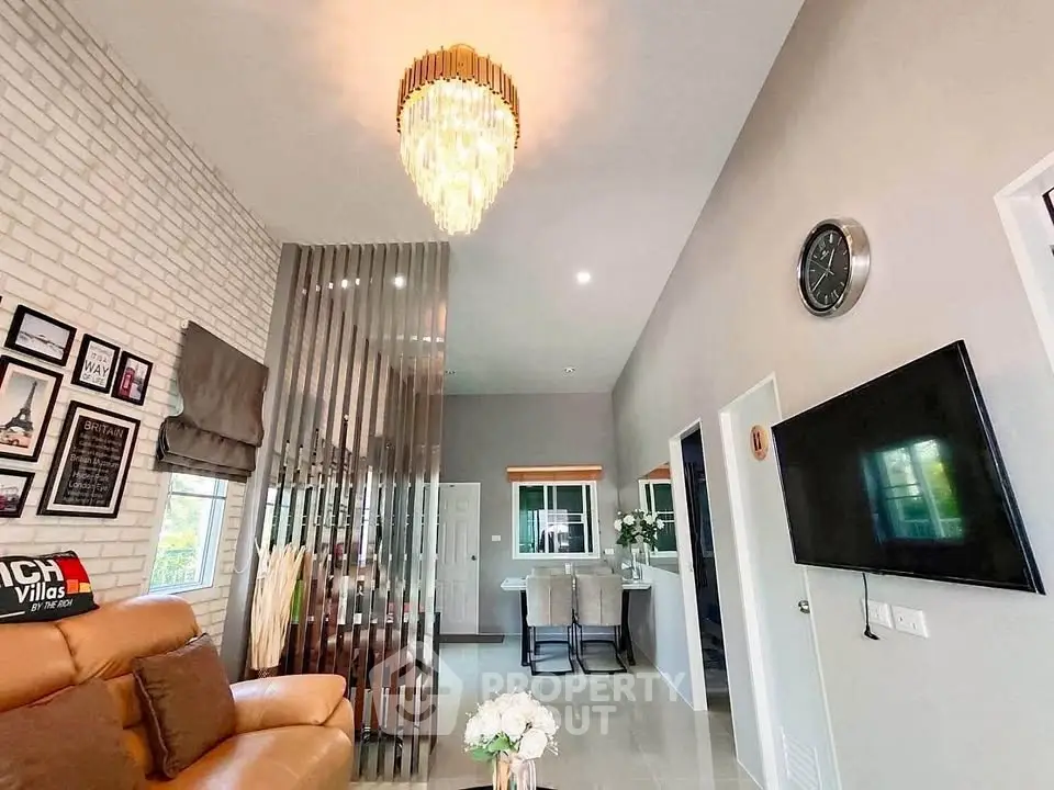 Modern living room with elegant chandelier and stylish decor
