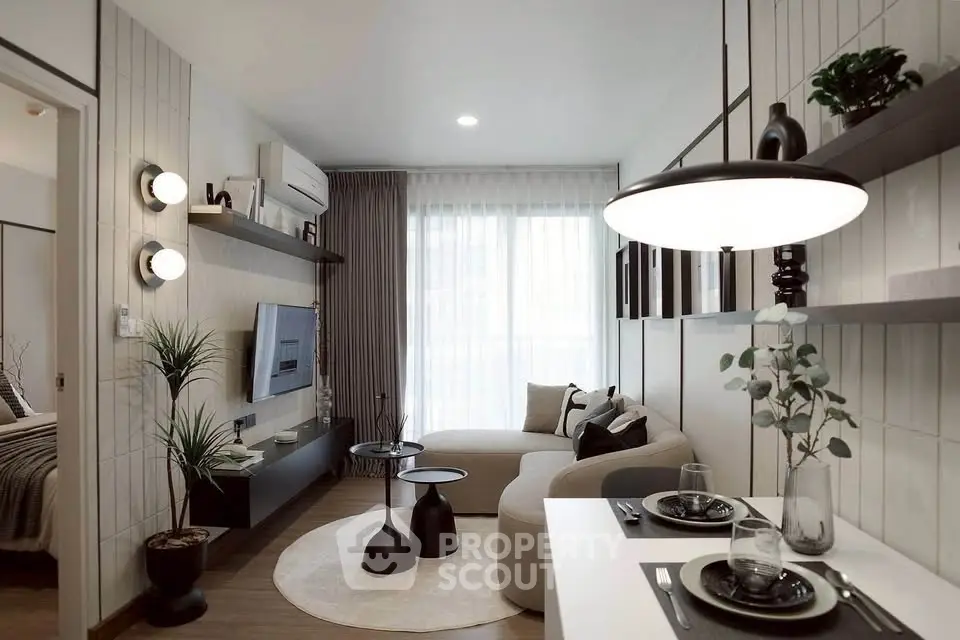 Modern living room with stylish decor and natural light, featuring a cozy sofa and elegant dining area.