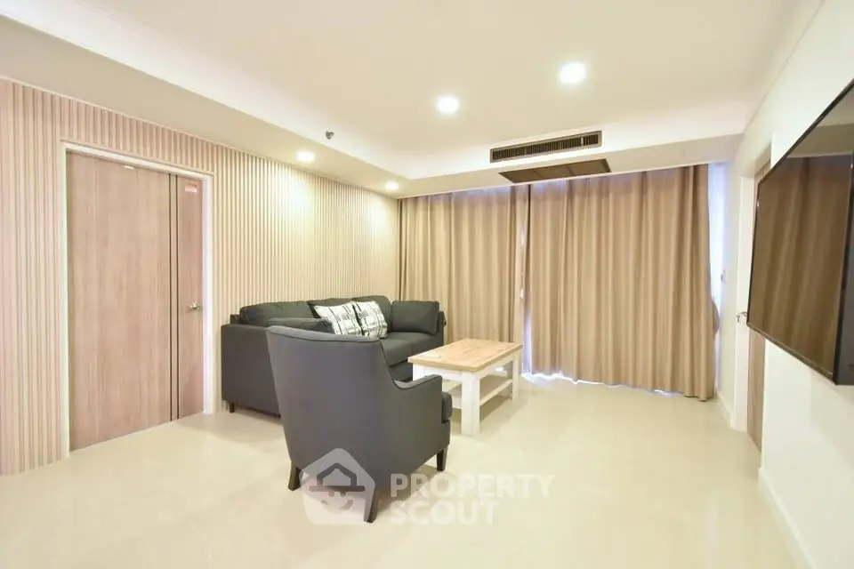 Spacious living room with modern furniture and elegant lighting