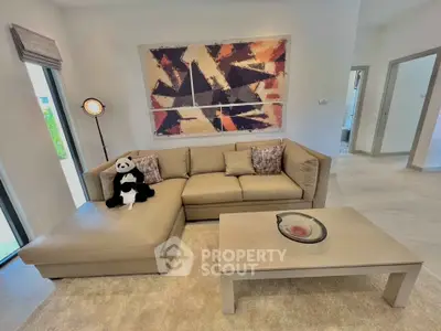 Modern living room with stylish decor and comfortable beige sectional sofa