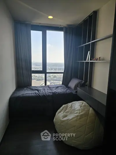 Cozy bedroom with large window offering stunning city view, modern shelving, and comfortable bedding.
