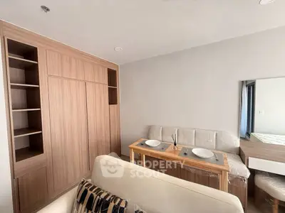 Modern living room with built-in wooden storage and cozy dining area.