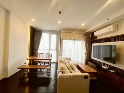 Spacious living room with modern decor and large windows for natural light.