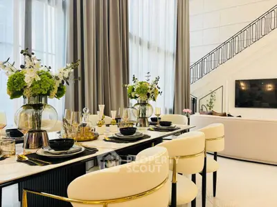 Luxurious living room with elegant dining area and high ceilings, perfect for sophisticated gatherings.