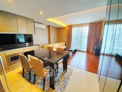 Modern living room with elegant dining area and large windows in a stylish apartment.
