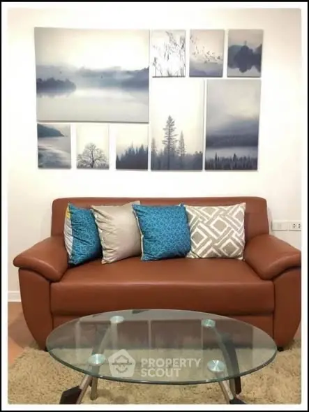 Stylish living room with modern sofa, elegant cushions, and artistic wall decor.