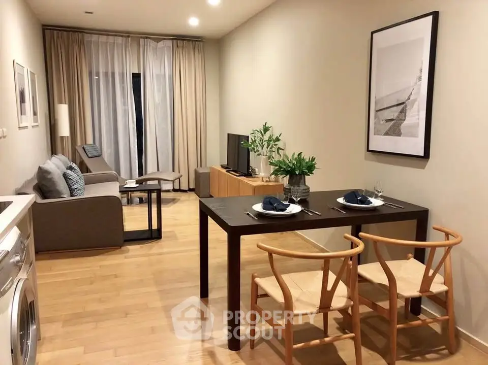 Modern living room with dining area, featuring stylish furniture and a cozy ambiance.