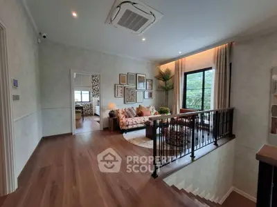 Stylish living room with elegant decor and large window offering a serene view, perfect for relaxation.