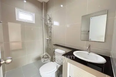 Modern bathroom with sleek fixtures and neutral tiles