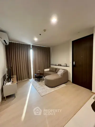 Modern living room with cozy sofa and stylish decor in a contemporary apartment.