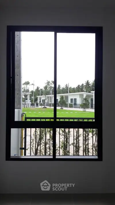 Modern window view of contemporary homes and lush greenery.