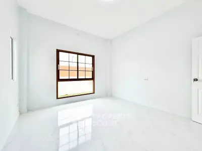 Bright and spacious empty room with large window and glossy white floor tiles.