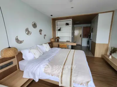 Spacious modern bedroom with stylish decor and open layout, featuring a cozy bed and elegant wooden furnishings.