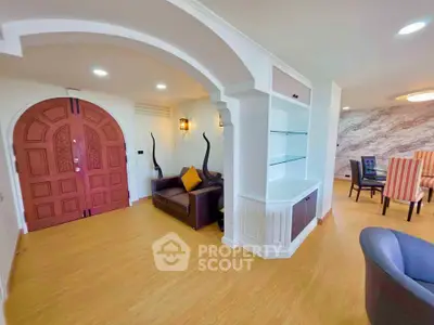 Spacious living room with elegant archway and modern decor