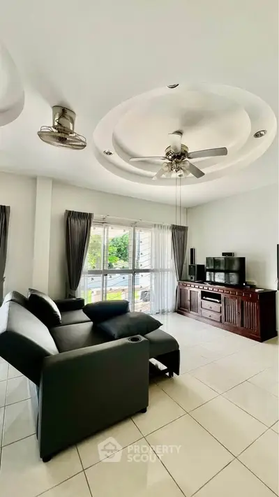 Spacious living room with modern furniture and large windows offering natural light.