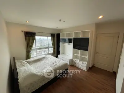 Spacious bedroom with city view and modern built-in storage
