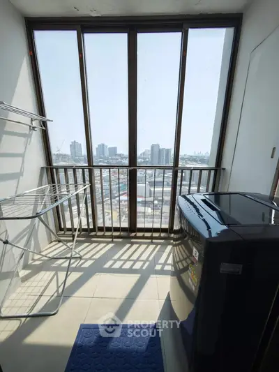 High-rise apartment balcony with city view and washing machine, perfect for urban living.