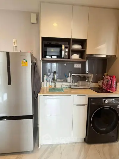 Modern compact kitchen with sleek appliances and efficient layout