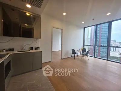 Modern open-plan kitchen and dining area with city view