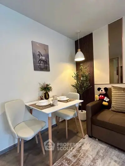 Cozy dining nook with modern decor and plush seating in stylish apartment.