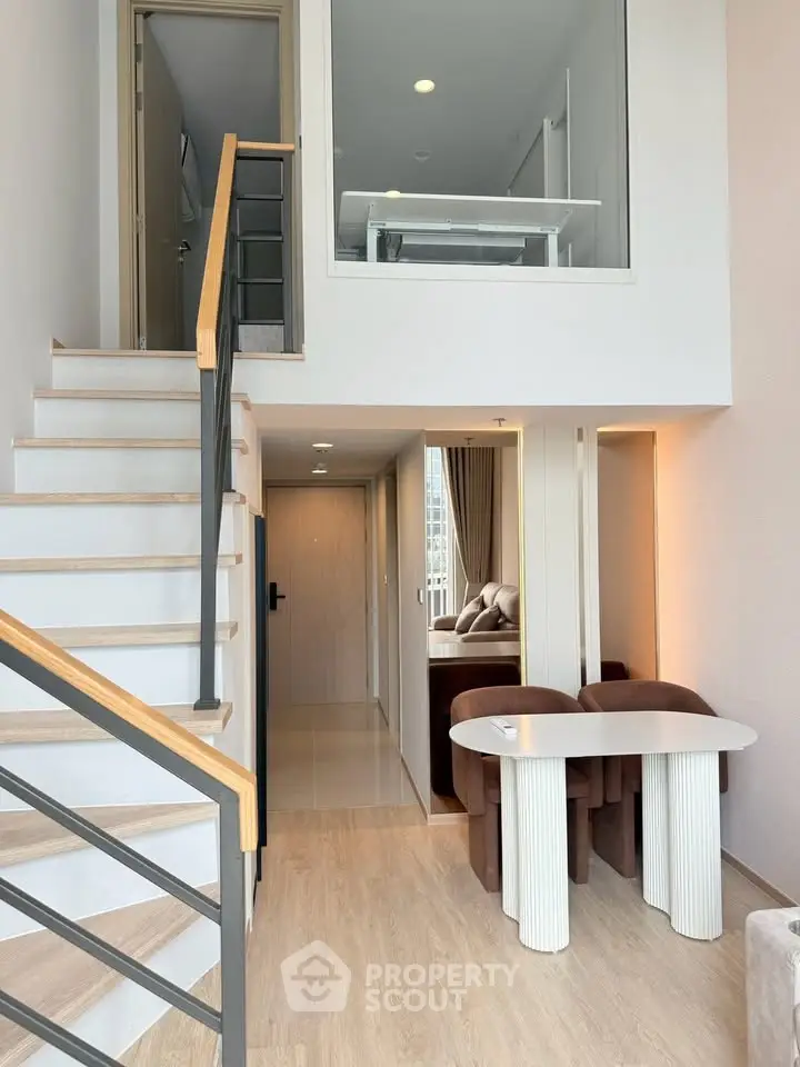 Modern duplex apartment with stylish staircase and cozy dining area