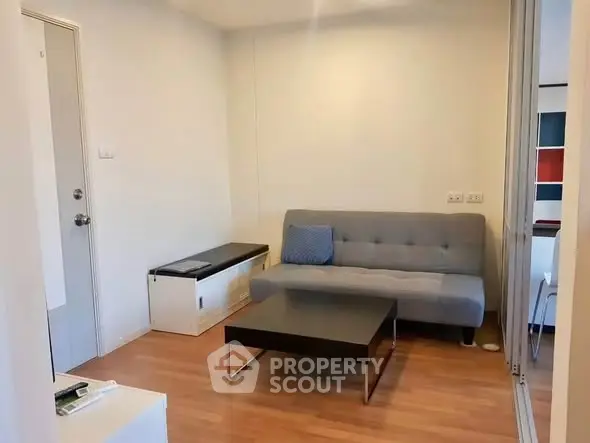 Cozy living room with modern sofa and coffee table, perfect for relaxation.
