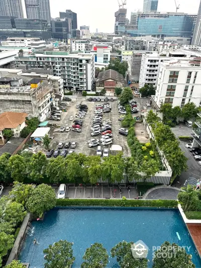 Stunning cityscape view with pool and parking area in vibrant urban setting