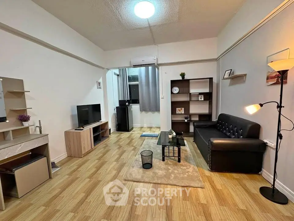 Modern living room with stylish furniture and wooden flooring, featuring a cozy ambiance and elegant decor.