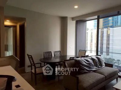 Modern living room with dining area and large windows in urban apartment