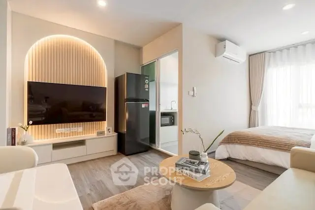 Modern studio apartment with stylish decor and open layout, featuring a cozy living area and compact kitchen.