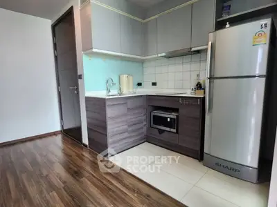 Modern compact kitchen with sleek cabinetry and stainless steel appliances