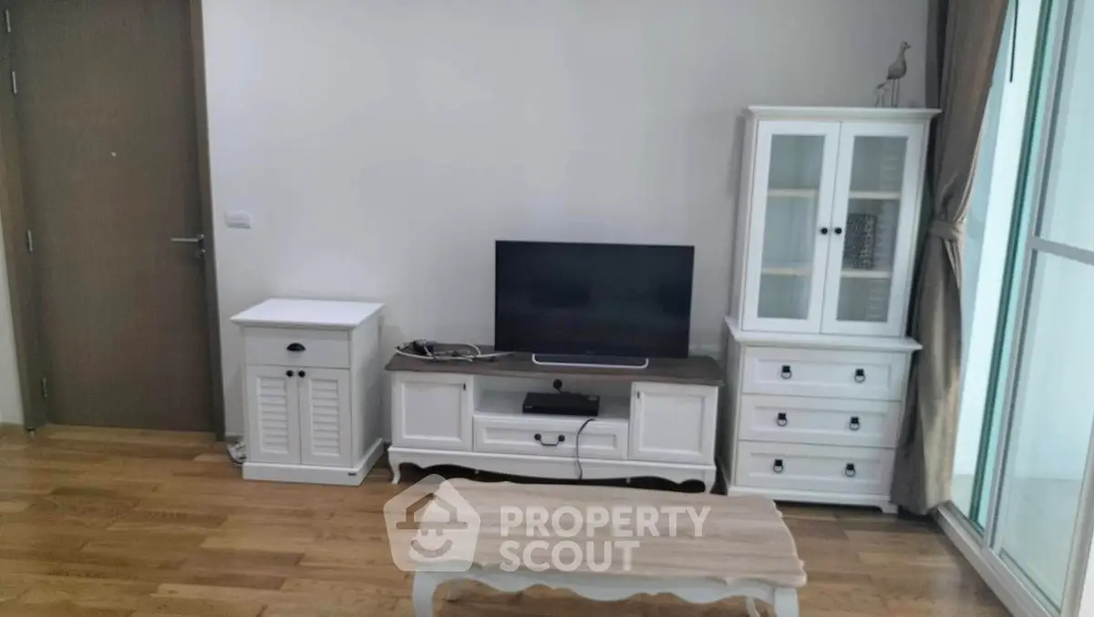 Charming living room with elegant white furniture and wooden flooring