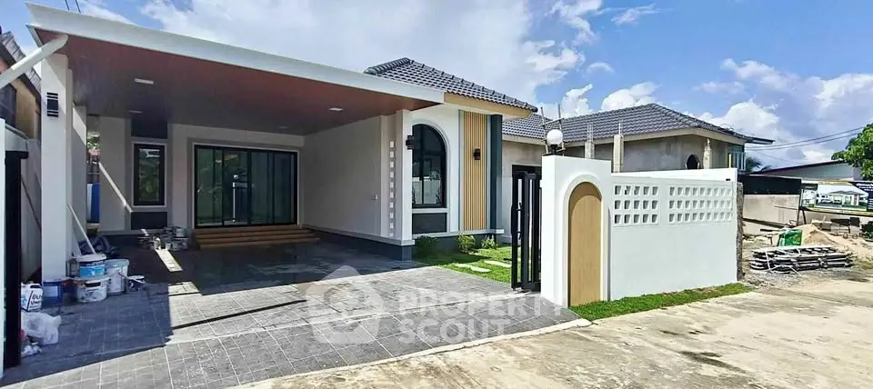 Modern single-story house with sleek design and spacious driveway, featuring a stylish entrance and contemporary architecture.