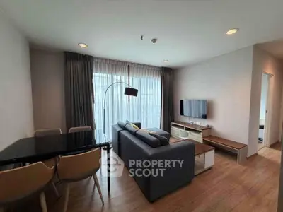Modern living room with stylish furniture and large windows in a contemporary apartment.