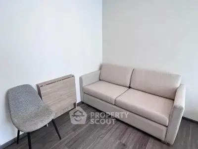 Cozy modern living room with stylish sofa and chair, perfect for relaxation.