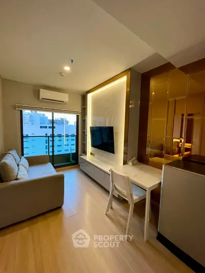 Modern living room with sleek design, featuring a comfortable sofa, wall-mounted TV, and stylish lighting.